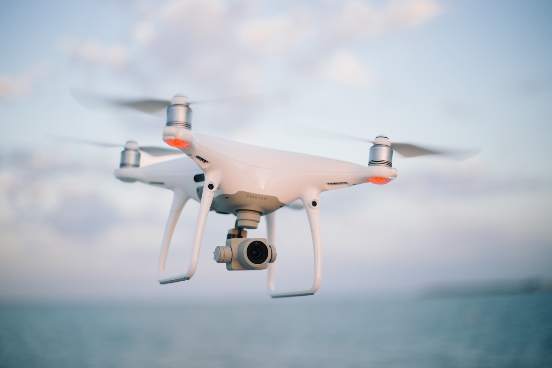 DJI Phantom camera drone flying with its gimbal camera pointing forward