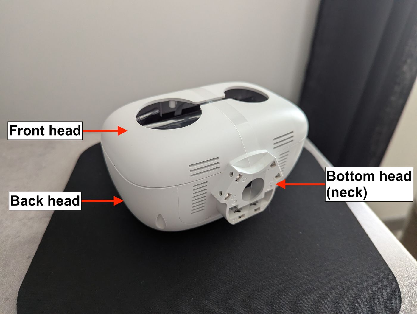 Disassembled white Reachy Mini head shell showing camera cutouts